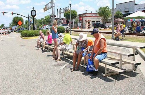 A small crowd gathered at the stage to listen to performers sing and to music sponsored by Banana Jack Murphey.